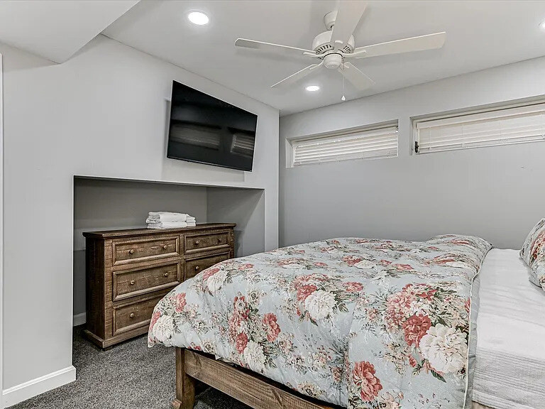 An Azalea bedroom with a patterned duvet and a glazed door opening onto the patio