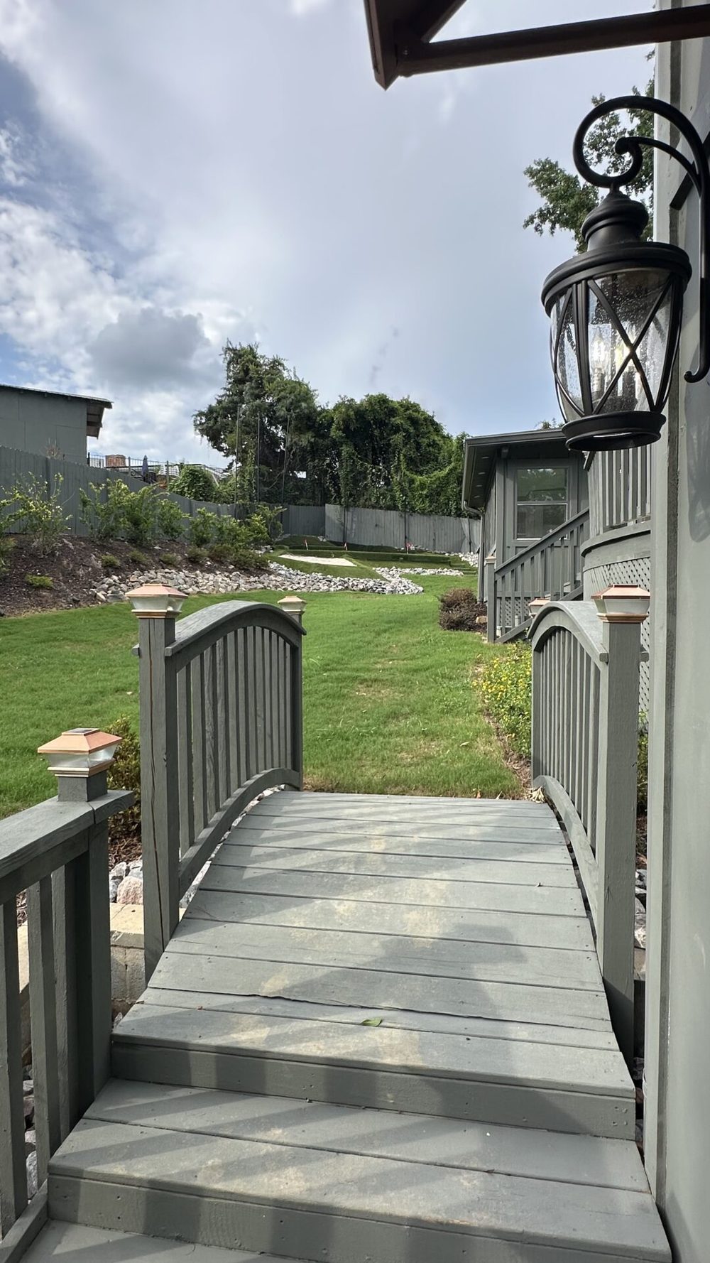 The walkway along the side of the house leading to the ground-floor private entrances