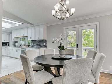The dining area beside the marble fireplace in the main home, set for a seated dinner
