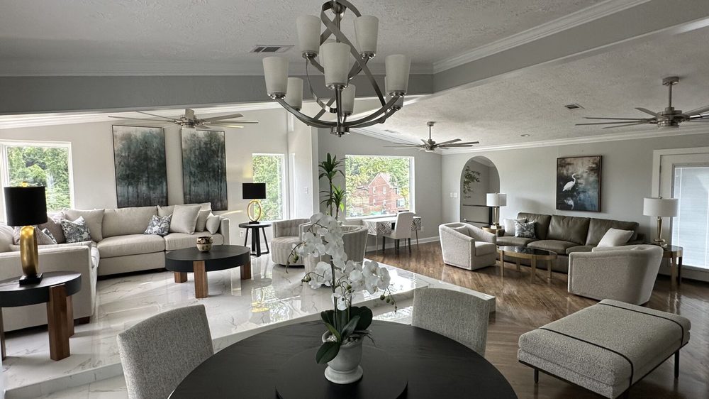 The Magnolia's open living and dining rooms: designer-styled dual seating, chandelier, and marble sunken entry with hardwood floors